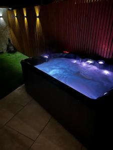a large hot tub with lights in a room at Luxe City Hot Tub: Urban Retreat in Norwich