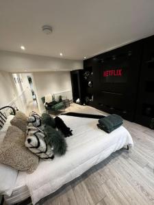a large bed in a room with a melfix store at Luxe City Hot Tub: Urban Retreat in Norwich