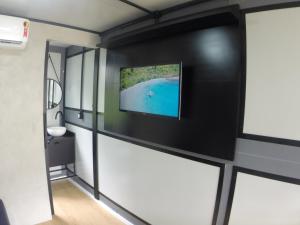 a room with a flat screen tv on a wall at Tiny House Urban in Balneário Camboriú