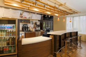 a bar in a restaurant with a counter and stools at Courtyard by Marriott San Antonio Airport/North Star Mall in San Antonio