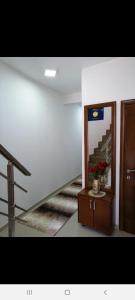 a room with a staircase and a table with a mirror at Apartments Gazi in Ulcinj