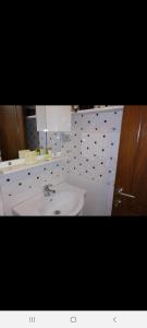 a bathroom with a white sink and a mirror at Apartments Gazi in Ulcinj