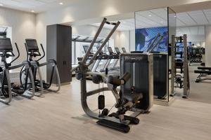 a gym with treadmills and cardio equipment in a room at Delta Hotels Calgary Airport In-Terminal in Calgary