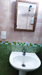 a bathroom with a white sink and a mirror at Sombra in Ciudad de la Costa