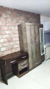 a kitchen with a brick wall and a refrigerator at Sombra in Ciudad de la Costa