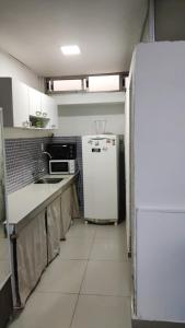 a kitchen with a white refrigerator and a sink at Sombra in Ciudad de la Costa