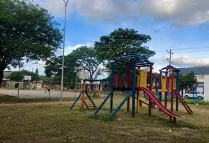 a playground with a colorful play set in a park at Casa Beni para estrenar in Santa Cruz de la Sierra