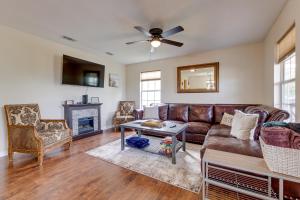 a living room with a couch and a fireplace at Charming Biloxi Vacation Rental Near Beach! in Biloxi