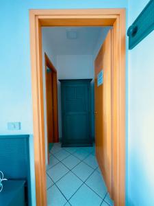 a hallway with a blue door in a room at Baia di Talamone in Talamone