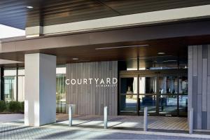 a building with a court yard sign on the side of it at Courtyard Baltimore Downtown/McHenry Row in Baltimore