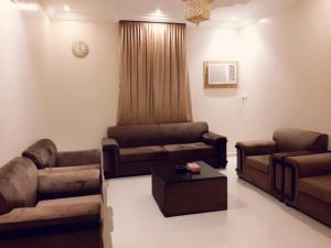 a living room with couches and a couch and a table at Ritan Apart-Hotel in Taif