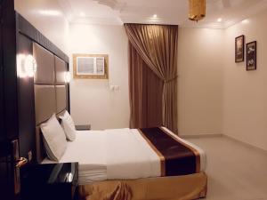 a hotel room with a bed and a window at Ritan Apart-Hotel in Taif