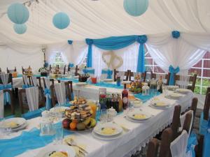 a table set up for a party with blue and white decorations at Gościniec Grek Zorba - pokoje i domki 4 osobowe - 16km od Zator Energylandia in Inwałd