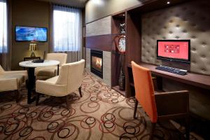 a hotel room with a fireplace and a desk with a computer at Marriott Quebec City Downtown in Quebec City
