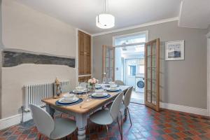 a dining room with a wooden table and chairs at Glanrhyd Townhouse in Central Dolgellau with Parking and Bike Storage in Dolgellau