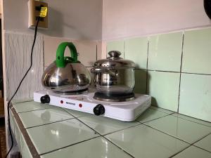 a tea kettle on top of a blender on a counter at Tanguitos in Sucre