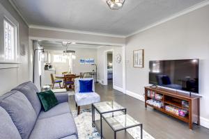 a living room with a couch and a tv at Rochester Vacation Rental about 1 Mi to Downtown in Rochester