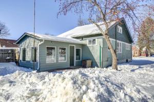 a blue house with snow in front of it at Rochester Vacation Rental about 1 Mi to Downtown in Rochester