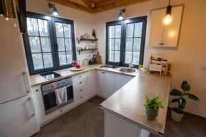 a kitchen with a white refrigerator and a sink at Apartman TALIJA in Pirot