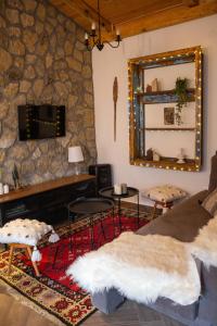 a living room with a fireplace and a mirror at Apartman TALIJA in Pirot