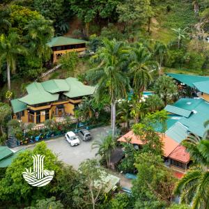 an aerial view of a house with palm trees at Boutique Hotel Las Cascadas in Manuel Antonio