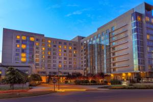 a large white building with many windows at dusk at Bethesda North Marriott Hotel & Conference Center in Bethesda