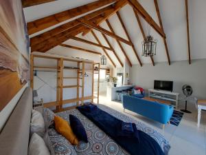 a bedroom with a bed and a living room at Cape Dutch Flair in Durbanville