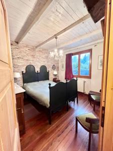 a bedroom with a bed and a brick wall at Casa Unica- da Bruno in Colico +77 photos