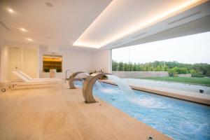 a swimming pool with a water slide in a house at Agroturismo Safragell Ibiza Suites & Spa in Sant Llorenç de Balafia