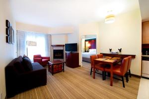 a living room with a couch a table and a living room at Residence Inn by Marriott Toronto Vaughan in Vaughan