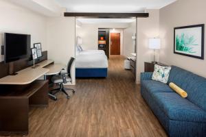 a hotel room with a couch and a desk and a bed at Fairfield Inn & Suites by Marriott Ocean City in Ocean City