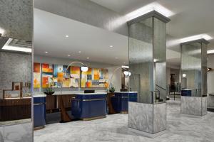 a lobby of a hotel with a reception desk at Le Méridien St. Louis Clayton in Clayton