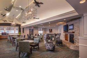 a restaurant with tables and chairs and a fireplace at Residence Inn Chantilly Dulles South in Chantilly