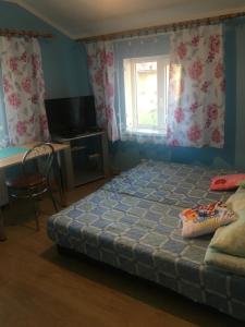 a bedroom with a bed and a desk and a window at Kwatery Prywatne u Gosi nad Soliną in Solina