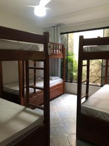 a room with three bunk beds and a window at Get Up Hostel in Natal