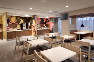 a restaurant with tables and chairs and a counter at Fairfield Inn & Suites by Marriott Springfield North in Springfield