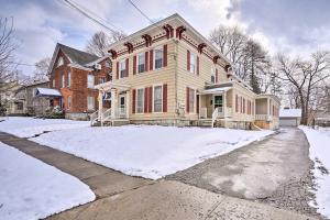 a house with snow in front of it at Dog-Friendly Downtown Auburn Vacation Rental! in Auburn