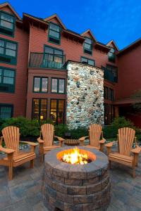 a fire pit in front of a building with chairs at Courtyard Marriott Lake Placid in Lake Placid