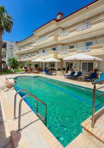 a swimming pool in front of a hotel at Melis Studios in Kallithea Halkidikis