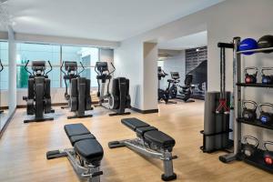 a gym with several treadmills and exercise bikes at Delta Hotels by Marriott Milwaukee Northwest in Menomonee Falls