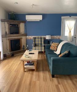 a living room with a couch and a coffee table at Whispering Waves Cottages in Shelburne