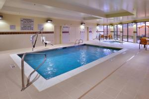a large swimming pool in a hotel lobby at Courtyard by Marriott Lehi at Thanksgiving Point in Lehi
