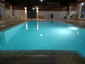 a large blue swimming pool at night at Apartamentos Atenea Jerte in Jerte