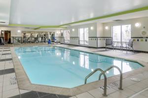 a large pool with blue water in a building at Fairfield Inn & Suites by Marriott Commerce in Commerce