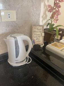 a toaster sitting on a counter next to a sign at Beautifull New 2 Bedroom Apartment in Amman in Amman