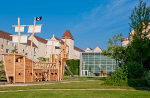 a playground in front of a building at Explorers Hotel Marne-la-Vallée in Magny-le-Hongre
