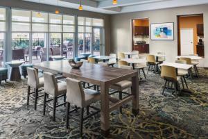 a dining room with a table and chairs at Residence Inn by Marriott Charleston North/Ashley Phosphate in Charleston