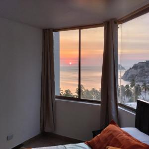 1 dormitorio con ventana y vistas al océano en CyM Arriendos 904, en Santa Marta