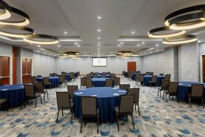 a conference room with blue tables and chairs at Delta Hotels by Marriott - Indianapolis Airport in Indianapolis
