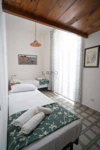 a bedroom with two beds and a window at Eirene 2 in Tropea